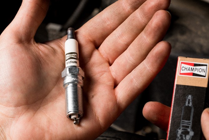 Hand holding a spark plug