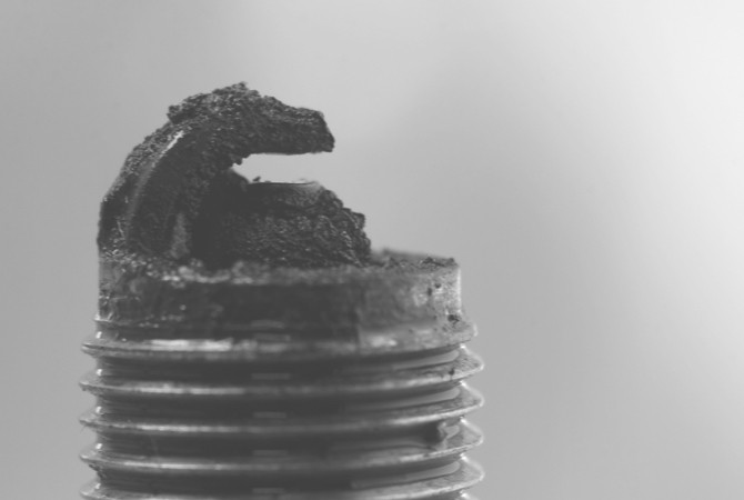Black, dry soot built up on the end of a spark plug