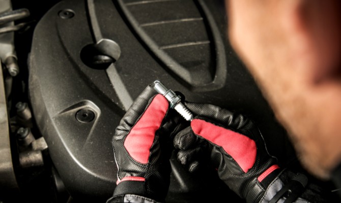 Technician-Installing-Spark-Plug-in-Car Technician-Installing-Spark-Plug-in-Car