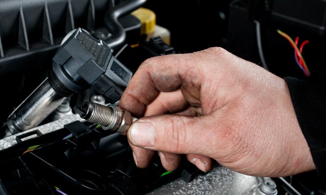 Mechanic-Holding-Spark-Plug Mechanic-Holding-Spark-Plug