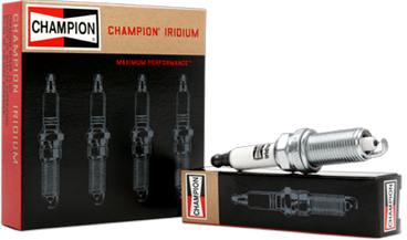 A Champion spark plug displayed next to the product's box