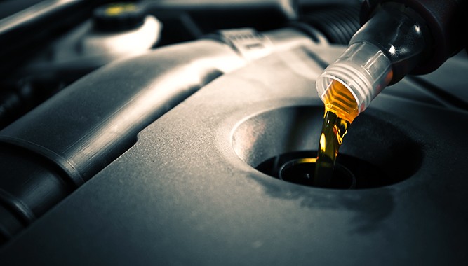Oil-Being-Added-To-Car-Engine Oil-Being-Added-To-Car-Engine