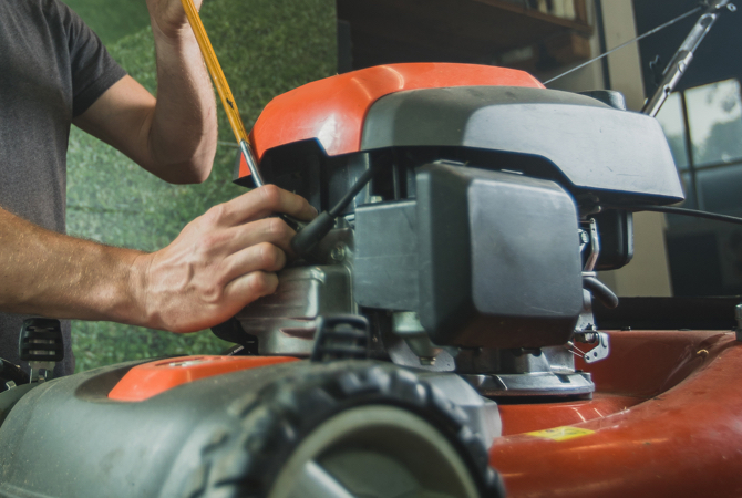 Man working on lawn mower engine