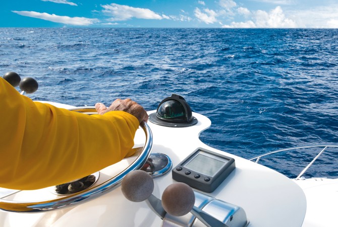 Person navigating their boat in the open water.